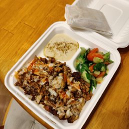 Al Basha chicken special with rice, hummus, pita, and salad