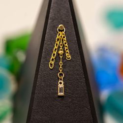 Ganesha Body Piercing - 14k Gold
Custom Triple Chain Charm
Featuring A Genuine Diamond Baguette
Assembled At Ganesha Body Piercing