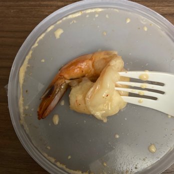 Mai Thai Restaurant - a plate of shrimp and sauce with a fork - Thai Near Me - Fort Worth, Texas