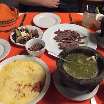 Mi Ciudad - Clockwise from top: black beans, grilled flank steak, bubbling habanero sauce, melted cheese - Mexican Near Me - Puebla, PUE