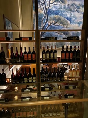 Photo of Felice 56 - New York, NY, US. a display of wine bottles and glasses