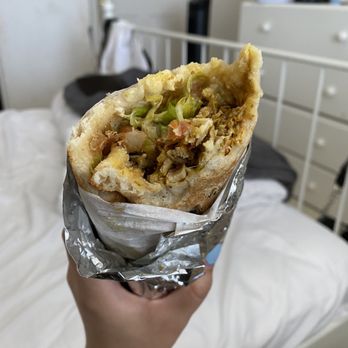 Pita Pockets - a hand holding a pita sandwich - Middle Eastern Near Me - Northridge, California Pita Pockets - a hand holding a pita sandwich - Middle Eastern Near Me - Northridge, California