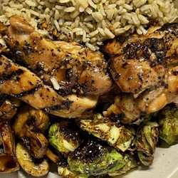 Eat Well Kitchen - Honey Soy grilled chicken thigh with mushrooms and brussel sprouts served over cilantro lime brown rice.