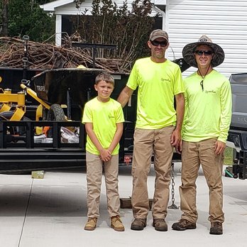 C H Lawn Care - a man and two boys standing in front of a truck - Lawn Services Near Me C H Lawn Care - a man and two boys standing in front of a truck - Lawn Services Near Me