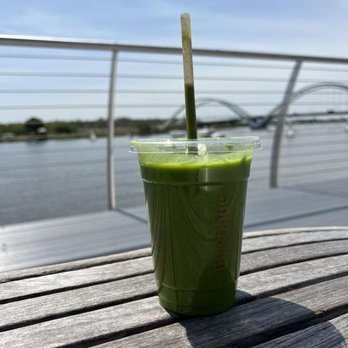 Toastique - a green smoothie in a plastic cup on a wooden table - Juice Bars & Smoothies Near Me - Washington, DC, District of Columbia Toastique - a green smoothie in a plastic cup on a wooden table - Juice Bars & Smoothies Near Me - Washington, DC, District of Columbia