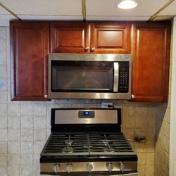 Family Wholesale Kitchens & Baths - The old cabinets above the microwave were 15". They replaced them with 12" and moved the microwave up for us.