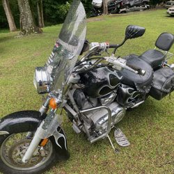 James' Body Shop - My bike in the middle of a yard in the rain.