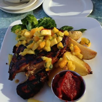 Emory's On Silver Lake - Island T-Bone Pork Chop with mango/pineapple salads and tomato/Sriracha sauce. - Steakhouses Near Me - Everett, Washington Emory's On Silver Lake - Island T-Bone Pork Chop with mango/pineapple salads and tomato/Sriracha sauce. - Steakhouses Near Me - Everett, Washington