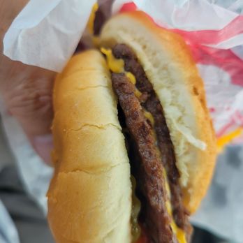 Wendy's - a hand holding a chili cheeseburger - Burgers Near Me - Coventry, Rhode Island Wendy's - a hand holding a chili cheeseburger - Burgers Near Me - Coventry, Rhode Island