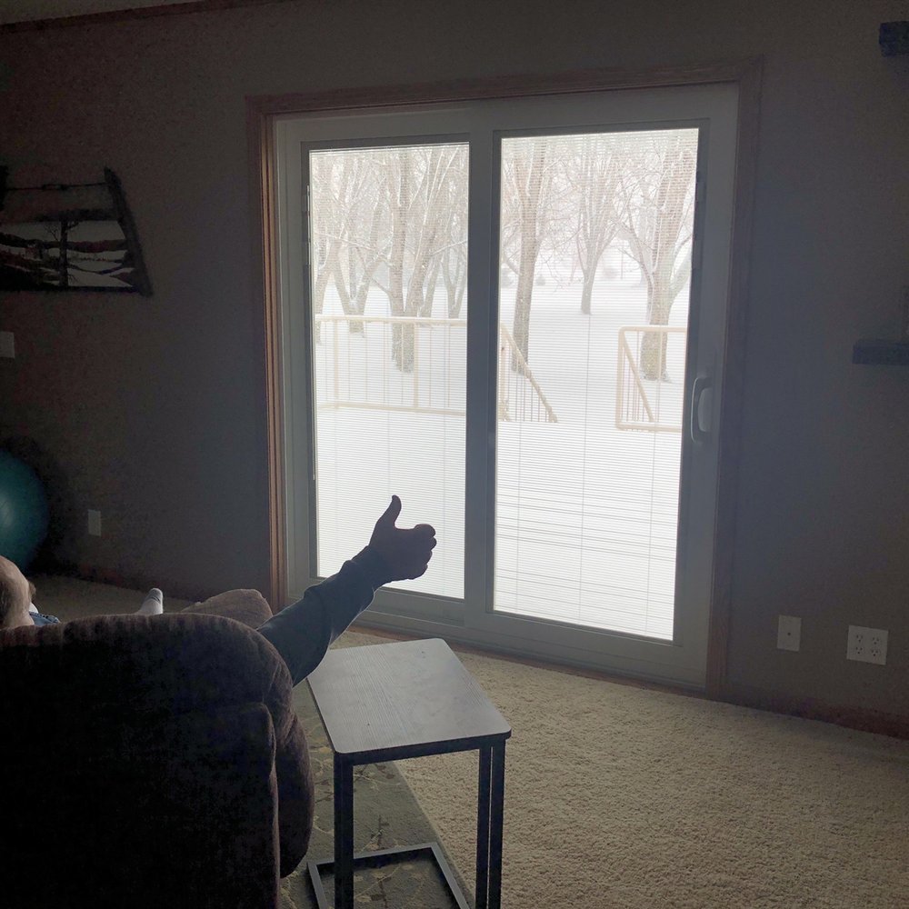 J & B Remodeling - a person sitting on a couch in front of a sliding glass door - General Contractors Near Me - Forest City, Iowa J & B Remodeling - a person sitting on a couch in front of a sliding glass door - General Contractors Near Me - Forest City, Iowa