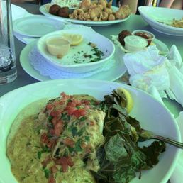 Catch of the day blackened with grits and greens. The other plate was fried clams, fish, and scallops.