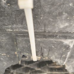 Spa Auto Collision - This a picture of the zip tie holding what's left of my engine splash shield in place.