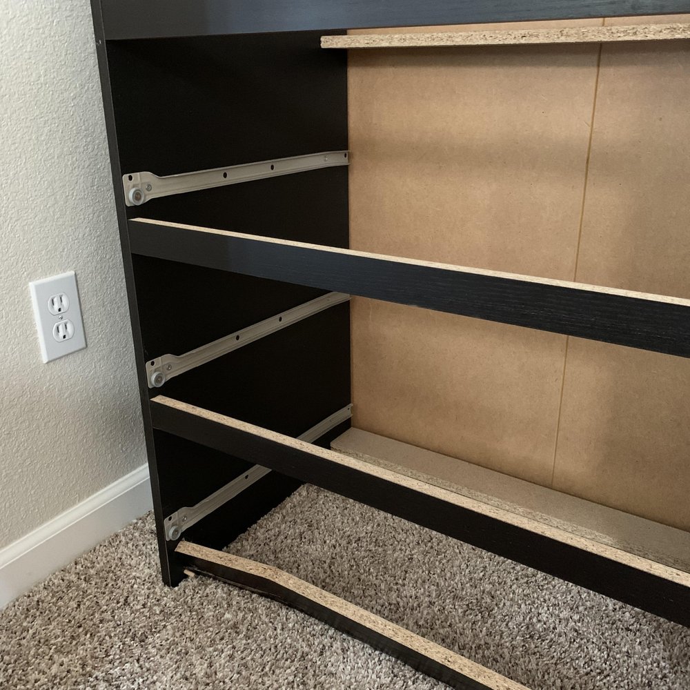Wrecked chest of drawers caused by dragging it across carpet.