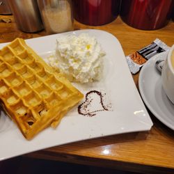 Café B20 - Latte and waffle with warm cherry compete and whipped cream.