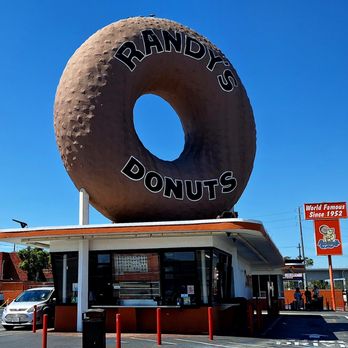 Randy's Donuts - You can see that there's a drive-through.  You can also see, from that sign beyond, they've been at this since 1952. - Donuts Near Me - Inglewood, California