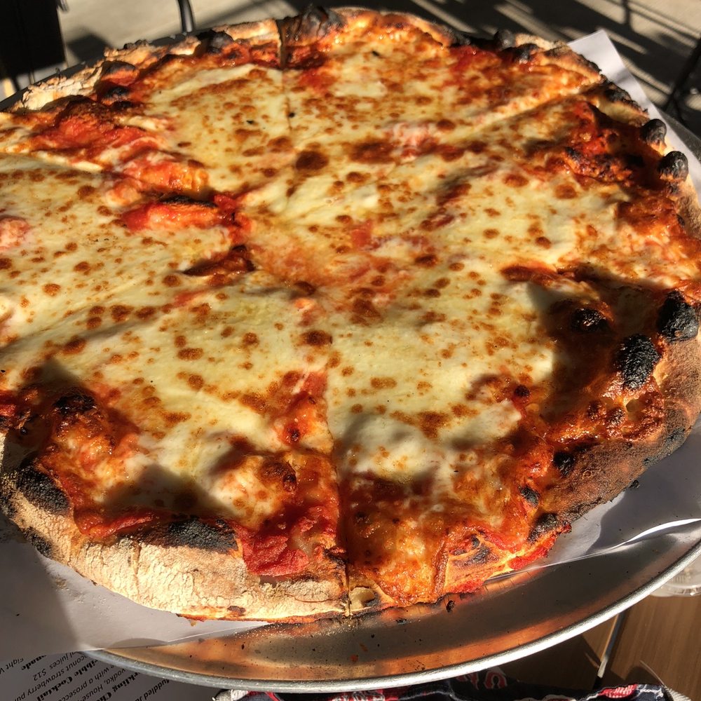 Max and Leo's - a cheese pizza on a platter - Pizza Near Me - Chelmsford, Massachusetts Max and Leo's - a cheese pizza on a platter - Pizza Near Me - Chelmsford, Massachusetts