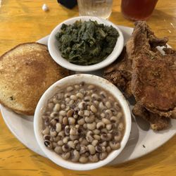 Fried pork chop, turnip greens, pan fried cornbread and black eyed peas