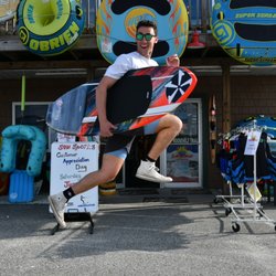 Sun Sports Plus - Jared holds a Phase 5 Wakesurf board