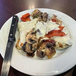 Thirsty Turtle Bar and Grill - Smothered Chicken with grilled mushrooms, onions, bell peppers and cheese