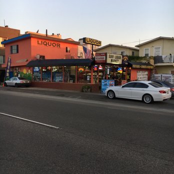 Surf Liquor - a white car parked on the side of the road - Beer, Wine & Spirits Near Me - Sunset Beach, California