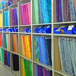 eQuilter.com - EQuilter Warehouse shelves filled with a rainbow of colors and patterns.