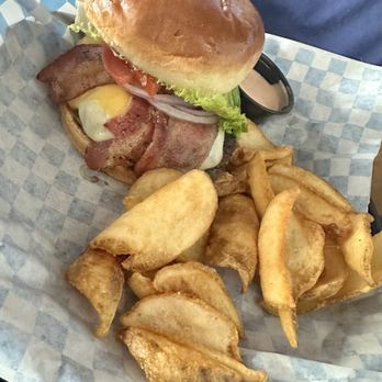 Eddie's Kitchen & Tavern - Signature Burger with Fries. The burger is 1/2 pound with thick cut bacon. - American Near Me - Spokane, Washington Eddie's Kitchen & Tavern - Signature Burger with Fries. The burger is 1/2 pound with thick cut bacon. - American Near Me - Spokane, Washington