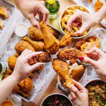 Bonchon Skokie - a table full of fried chicken and other food items - Chicken Wings Near Me - Skokie, Illinois