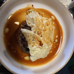 Korean patty with broth and egg.