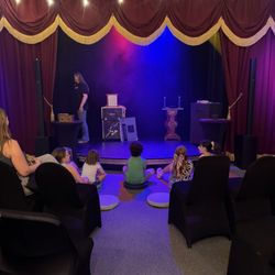 View of the stage and seating. Parents had covered chairs and kids sat on cushions. Lots of audience participation!