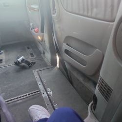 Triple M Transportation - Air conditioning with a view of road from van sliding door.