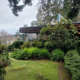 View of the entrance and lush gardens. View of the entrance and lush gardens.