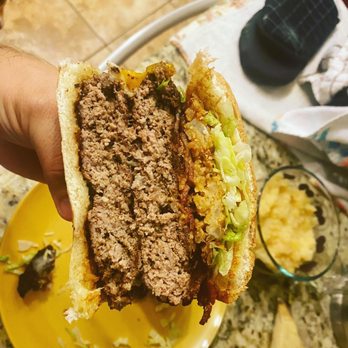 Toro Burger Bar - a hand holding a hamburger - Burgers Near Me - El Paso, Texas