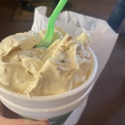 a hand holding a cup of cottage cheese a hand holding a cup of cottage cheese