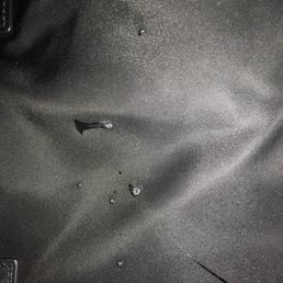 Spilled polish that splashed on purse Spilled polish that splashed on purse