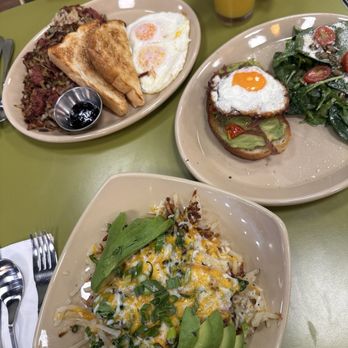 Snooze, an A.M. Eatery - Corned Beef Hash* top left Bravocado Toast*. Middle Spuds Deluxe* bottom - Breakfast & Brunch Near Me - Las Vegas, Nevada
