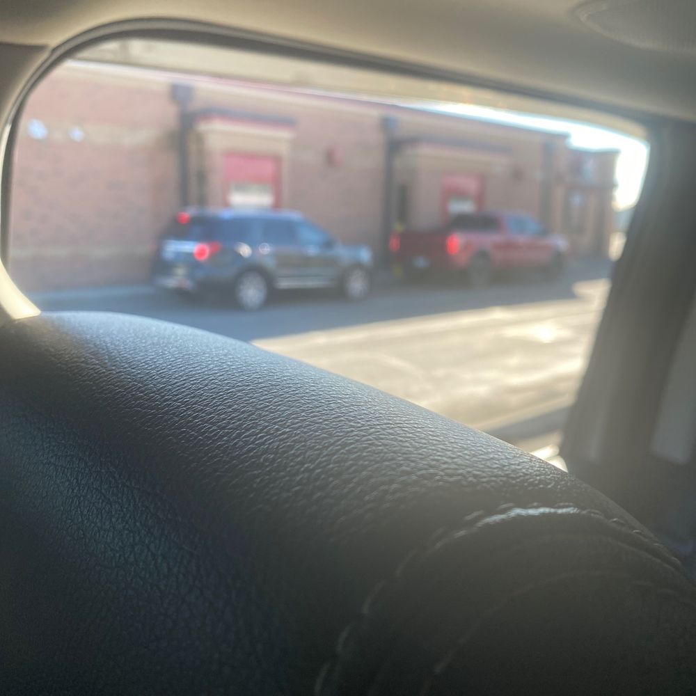 a view of a street through a car window a view of a street through a car window