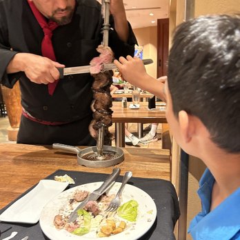 Pampas - So good! Grabbing the meats after it is cut. - Steakhouses Near Me - Las Vegas, Nevada