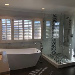 New tub, floor and wall tile, shower and vanities. New tub, floor and wall tile, shower and vanities.