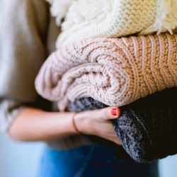 The Laundry Lifesaver - Three folded knitted blankets.