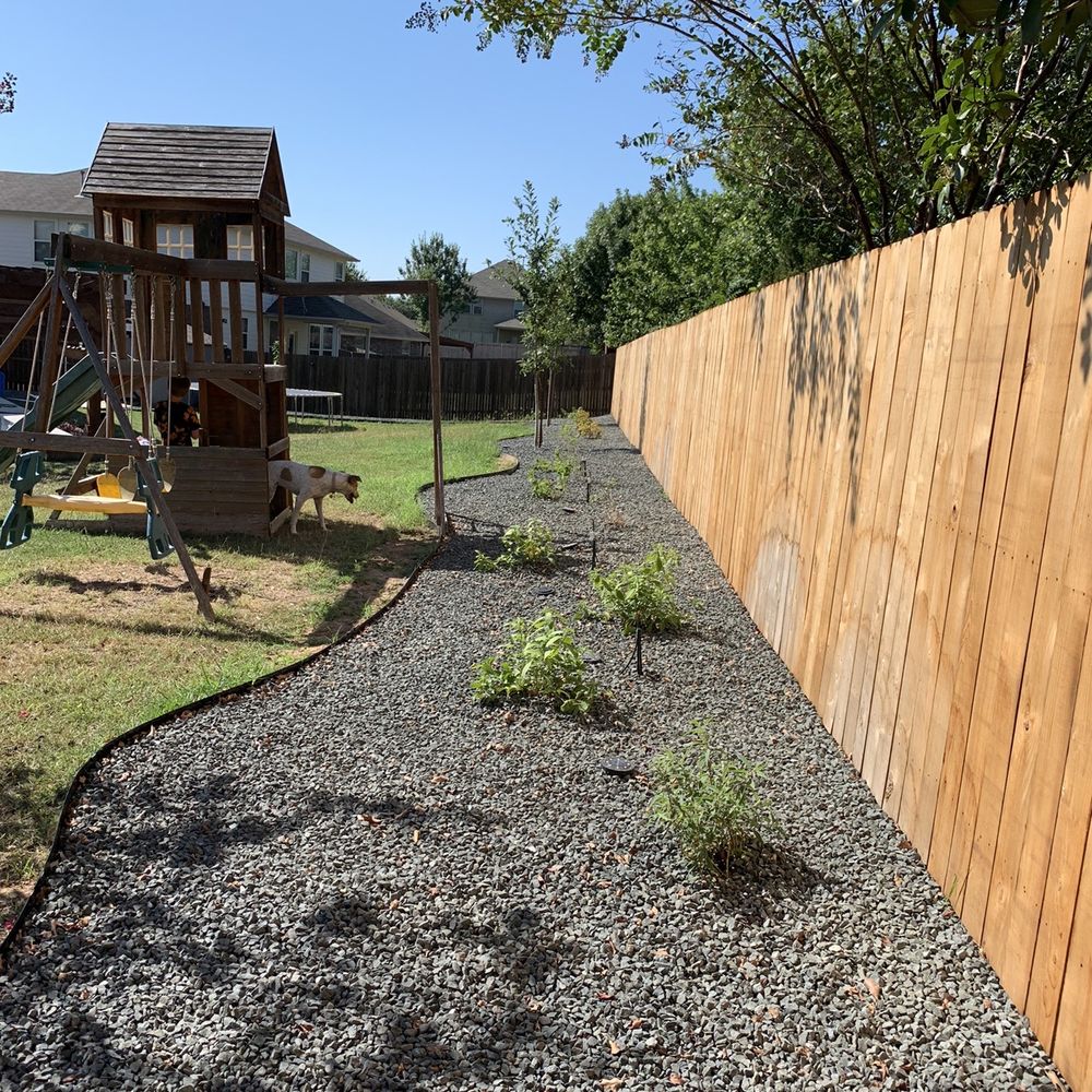 Rockview Landscapes - a backyard with a wooden fence - Landscaping Near Me - Bee Cave, Texas Rockview Landscapes - a backyard with a wooden fence - Landscaping Near Me - Bee Cave, Texas