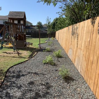 Rockview Landscapes - a backyard with a wooden fence - Landscaping Near Me - Bee Cave, Texas