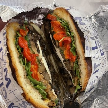 Lenwich - a half eaten sandwich in a wrapper - Salad Near Me - New York, New York