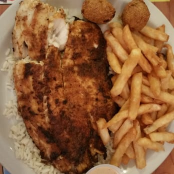 Catfish Haven - Blackened Tilapia on a bed of rice w/ fries - Seafood Near Me - Fredericksburg, Texas Catfish Haven - Blackened Tilapia on a bed of rice w/ fries - Seafood Near Me - Fredericksburg, Texas