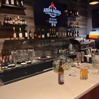Arepa Mania - a bar with bottles of beer on the counter - Bars Near Me - New Rochelle, New York Arepa Mania - a bar with bottles of beer on the counter - Bars Near Me - New Rochelle, New York