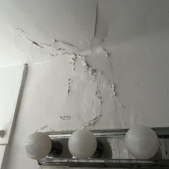 PPM Apartments - Bubbling and cracked plaster. Rusty light fixture - Property Management Near Me - Chicago, Illinois