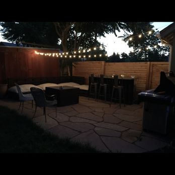 A Sharper Image Landscaping - a patio with a table and chairs - Landscaping Near Me