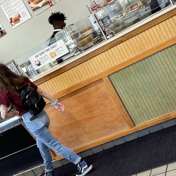 Bruegger's Bagels - You can clearly see the sunglasses, can around his neck and if you look closer you'll see he has no beard net - Sandwiches Near Me - Tallahassee, Florida Bruegger's Bagels - You can clearly see the sunglasses, can around his neck and if you look closer you'll see he has no beard net - Sandwiches Near Me - Tallahassee, Florida