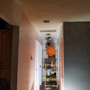 Interior Design Technicians - a man standing on a ladder - Drywall Installation & Repair Near Me Interior Design Technicians - a man standing on a ladder - Drywall Installation & Repair Near Me