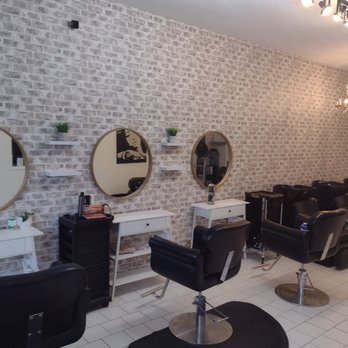Modern industrial-chic section of Elle Reve Salon with brick walls