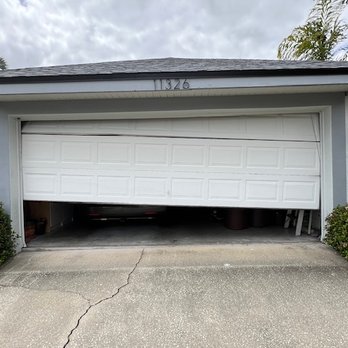 Above The Rest Doors - Door came off track and got jammed half-way open - Garage Door Services Near Me - Kissimmee, Florida Above The Rest Doors - Door came off track and got jammed half-way open - Garage Door Services Near Me - Kissimmee, Florida